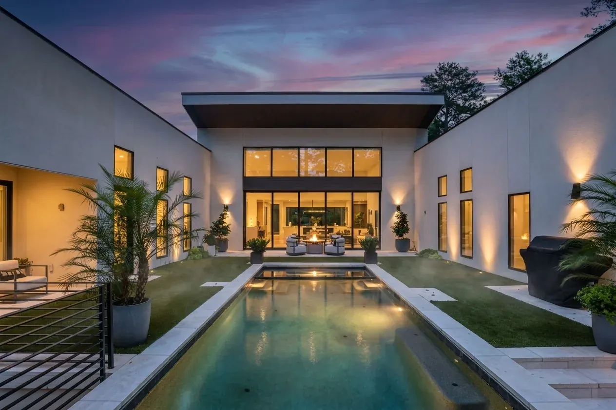 Daniel Allen Designs contemporary lap pool with fire pit in stucco courtyard wings in Buckhead, Georgia