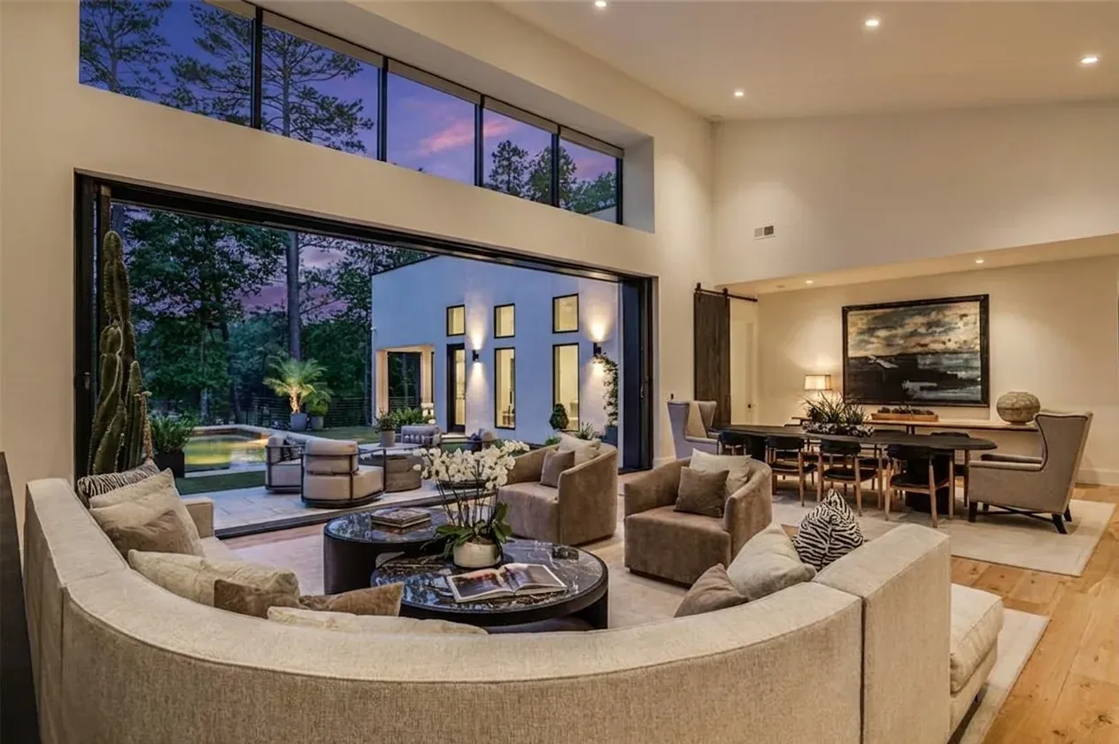 Daniel Allen Designs contemporary pool with rear yard pine trees at twilight in Buckhead, Georgia