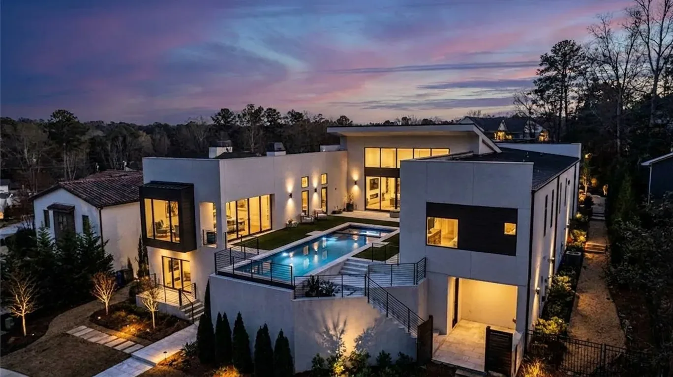 Daniel Allen Designs contemporary stucco and stone front elevation with wood garage door in Buckhead, Georgia