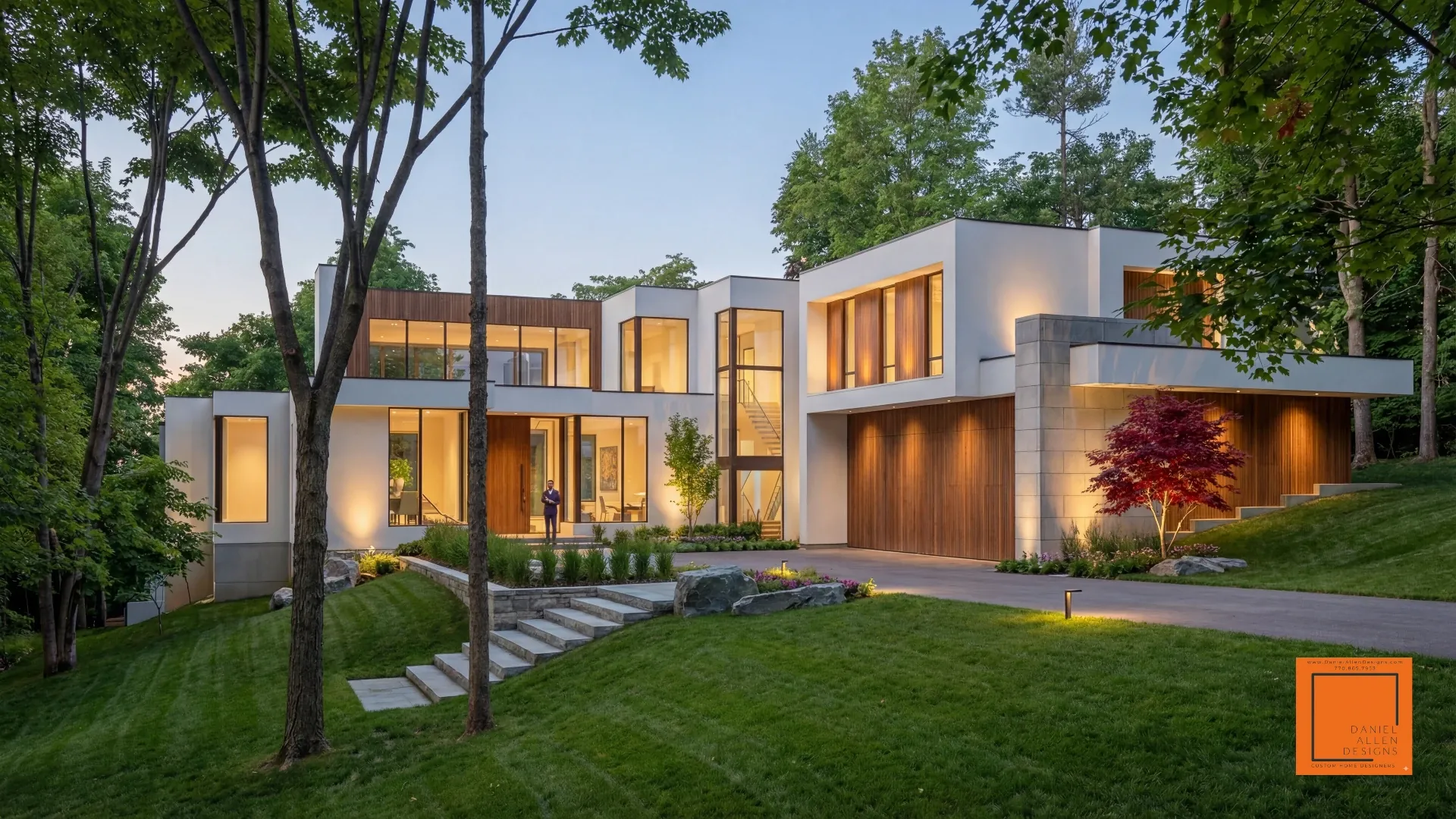 Daniel Allen Designs modern pavilion-style custom home in Tuxedo Park, Georgia — expansive glass walls with clean horizontal lines and warm dusk lighting