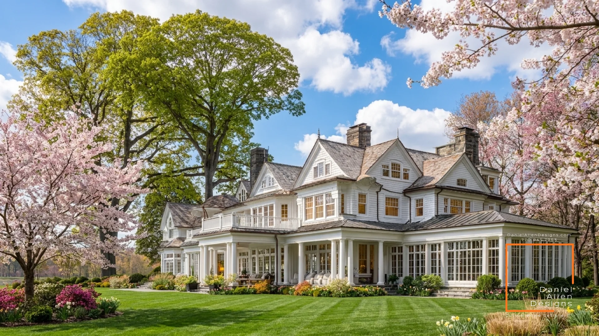 Design concept rendering by Daniel Allen Designs — custom shingle-style luxury estate with multi-gabled white shingle exterior, wraparound porch with classical columns, multiple chimneys, framed by spring cherry blossoms in Metro Atlanta, Georgia.
